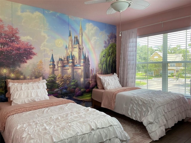 bedroom with dark hardwood / wood-style flooring and ceiling fan