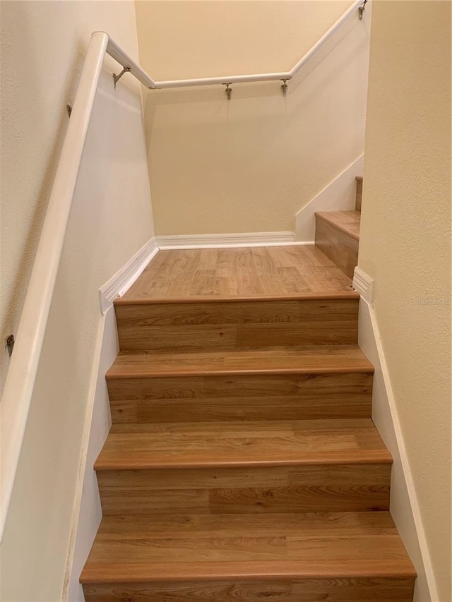 stairs featuring wood-type flooring