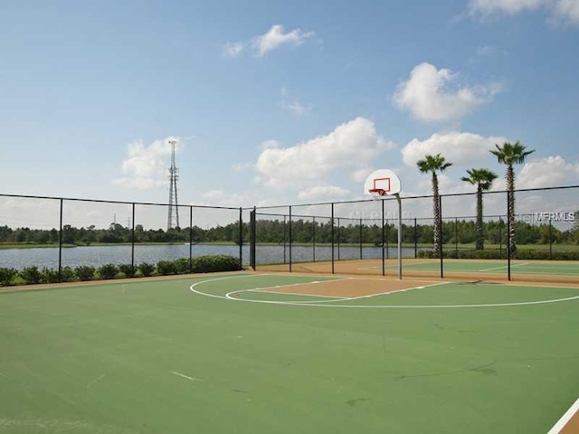 view of sport court featuring a water view