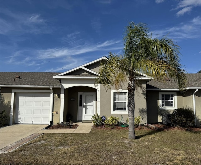 ranch-style house featuring a garage and a front yard