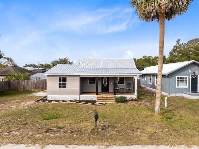 view of front of house with a front yard and covered porch