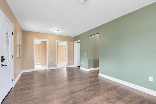 empty room featuring dark hardwood / wood-style floors