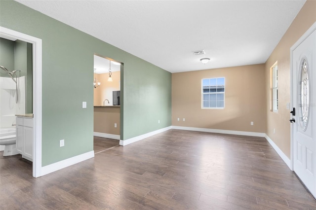 interior space featuring dark hardwood / wood-style floors and a chandelier