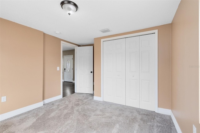 unfurnished bedroom with carpet floors and a closet