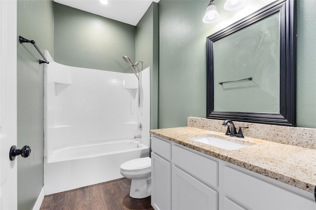 full bathroom with shower / washtub combination, toilet, wood-type flooring, and vanity