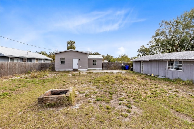 view of yard with an outbuilding and an outdoor fire pit