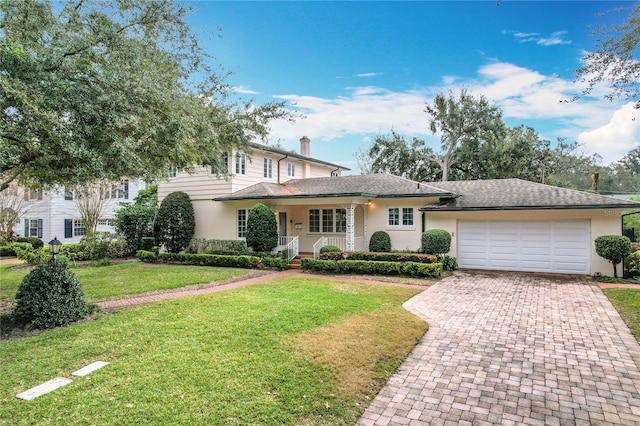 view of front of home featuring a garage and a front yard