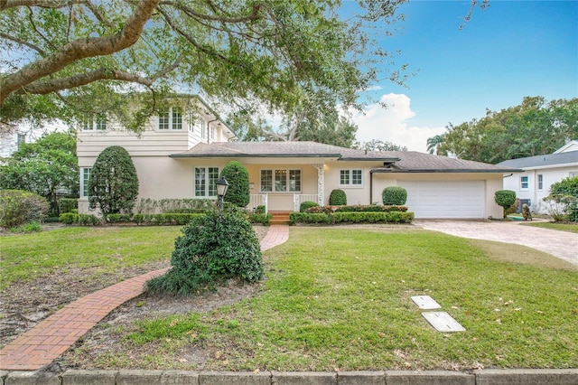 view of front of house featuring a garage, covered porch, and a front lawn