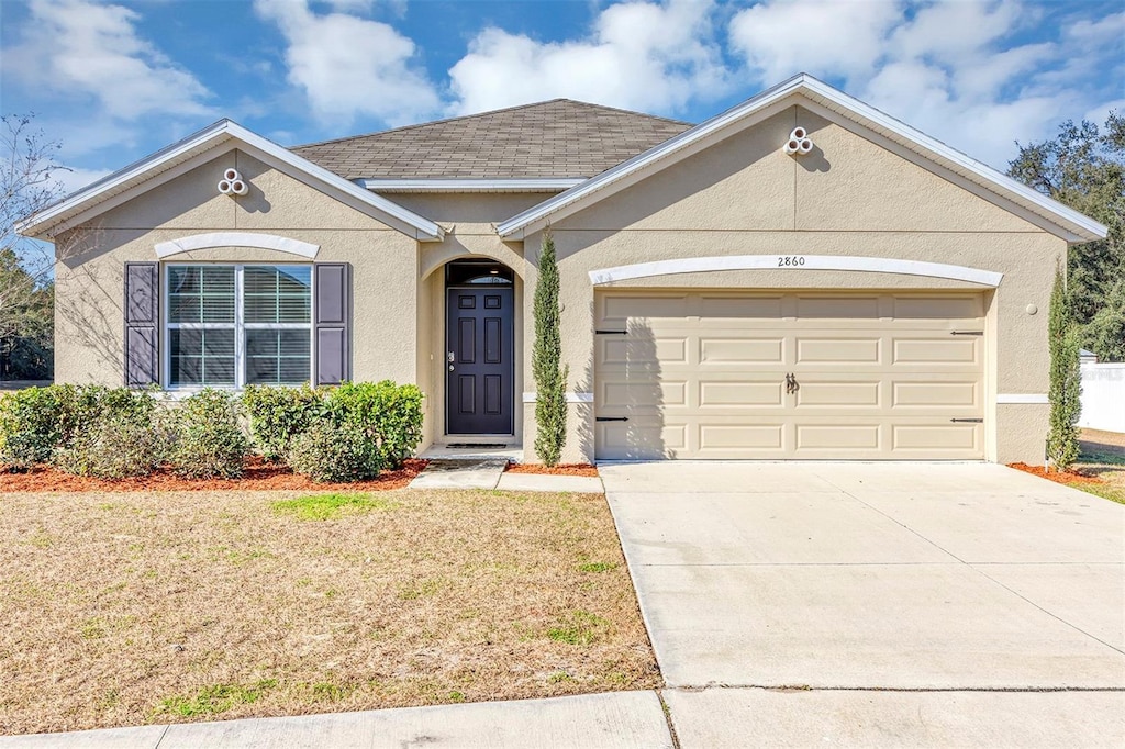 single story home with a garage