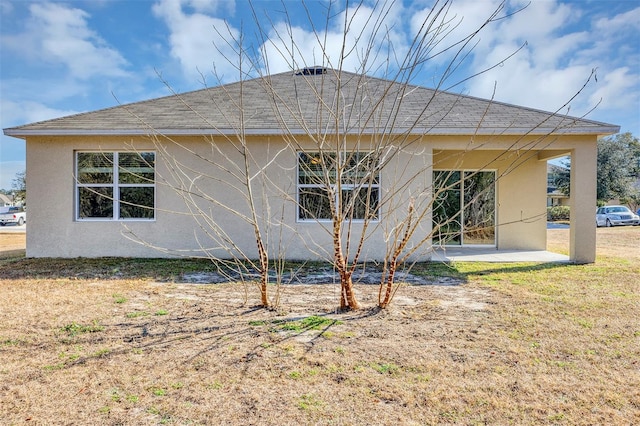 rear view of house featuring a yard