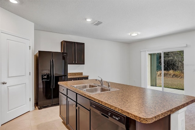 kitchen featuring an island with sink, sink, black appliances, dark brown cabinets, and a textured ceiling