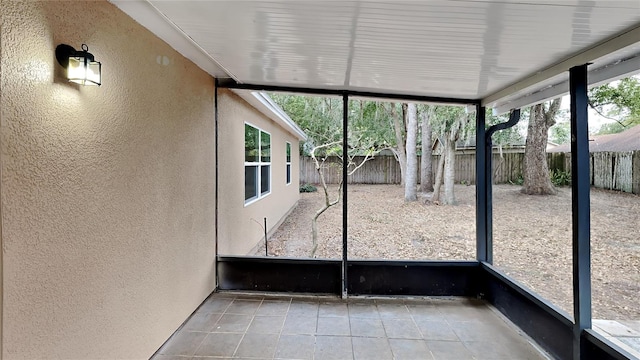 unfurnished sunroom featuring a wealth of natural light