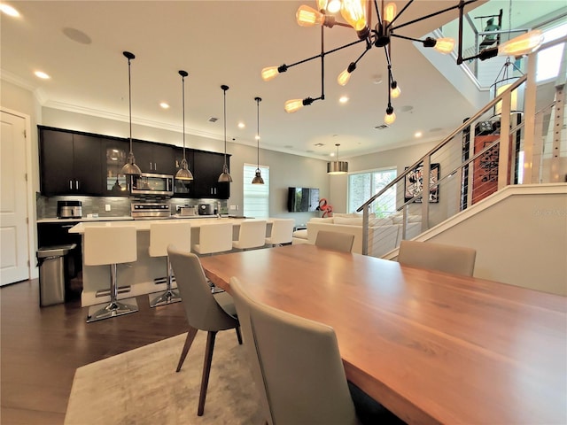 dining room with dark hardwood / wood-style flooring and ornamental molding