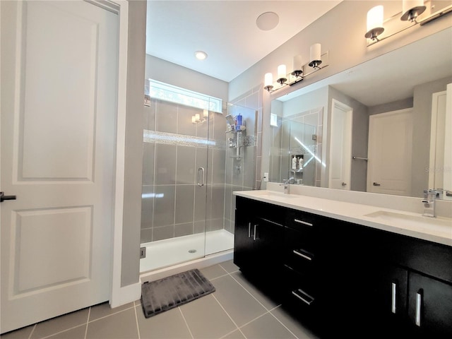 bathroom with vanity, a shower with door, and tile patterned flooring