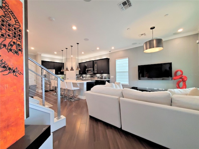 living room with crown molding and dark hardwood / wood-style floors