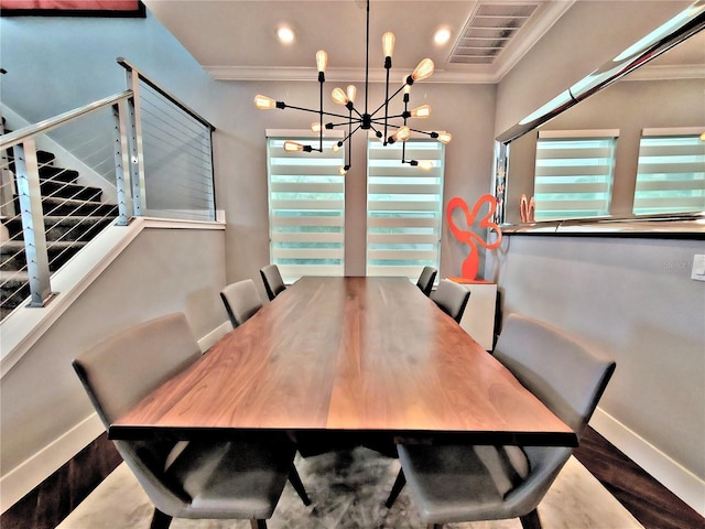 dining room featuring crown molding, a chandelier, dark wood-type flooring, and a wealth of natural light