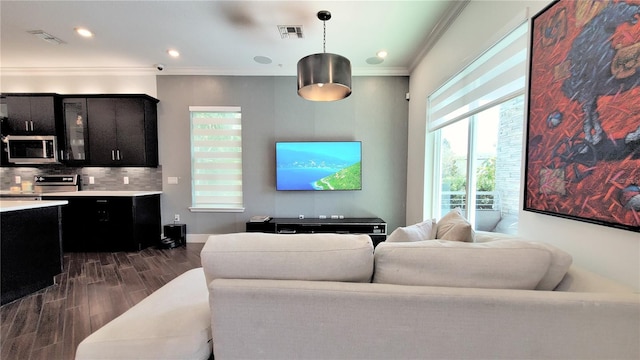 living room featuring dark hardwood / wood-style flooring and ornamental molding