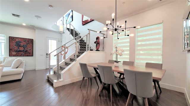 dining area with ornamental molding, dark hardwood / wood-style floors, and a notable chandelier