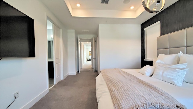 bedroom featuring a tray ceiling and light colored carpet