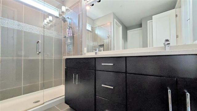 bathroom with vanity and an enclosed shower