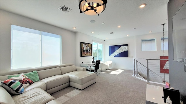 living room featuring light carpet and an inviting chandelier