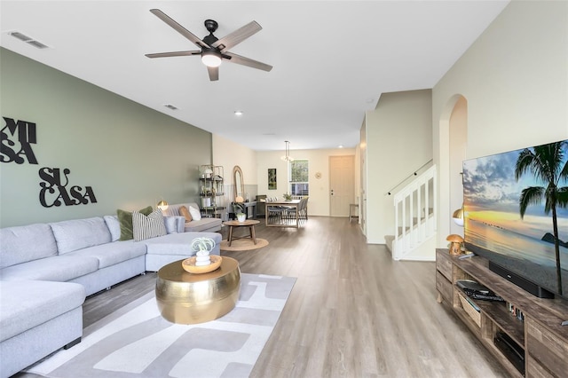 living room with ceiling fan and light wood-type flooring