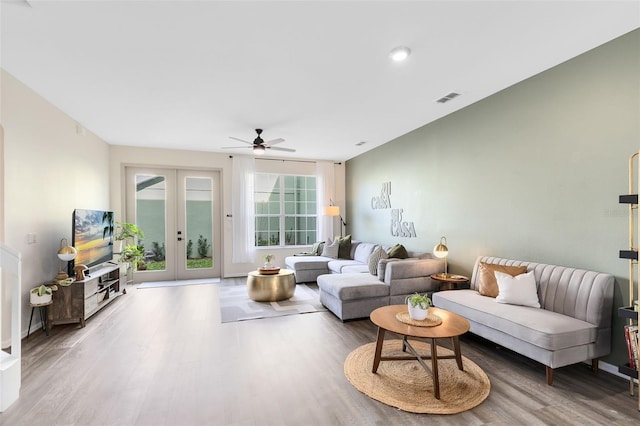 living room featuring french doors, ceiling fan, and wood-type flooring