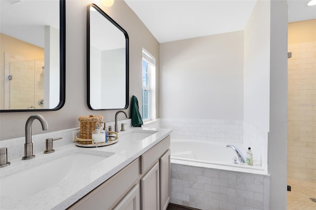 bathroom featuring vanity and independent shower and bath