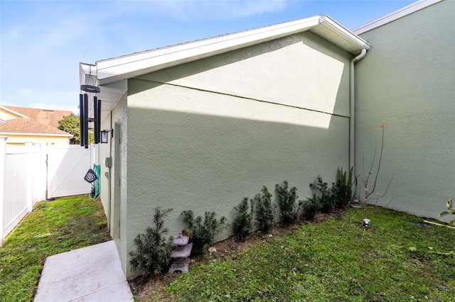 view of home's exterior with a lawn