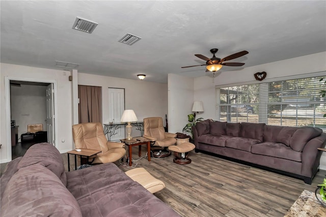 living room featuring ceiling fan and wood-type flooring