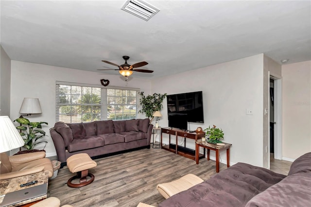 living room featuring ceiling fan and light hardwood / wood-style flooring