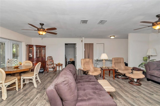 living room featuring ceiling fan and light wood-type flooring