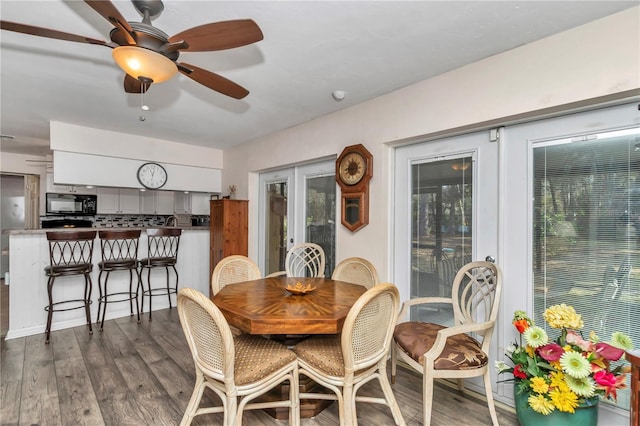 dining area with dark wood-type flooring, french doors, and ceiling fan