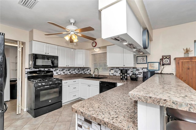 kitchen featuring white cabinetry, kitchen peninsula, and black appliances