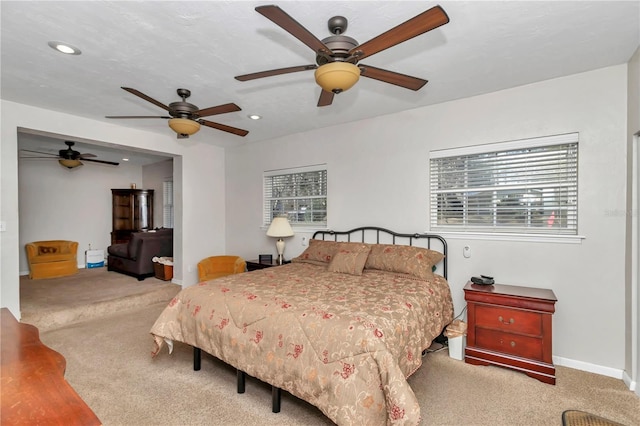 bedroom with ceiling fan and carpet flooring