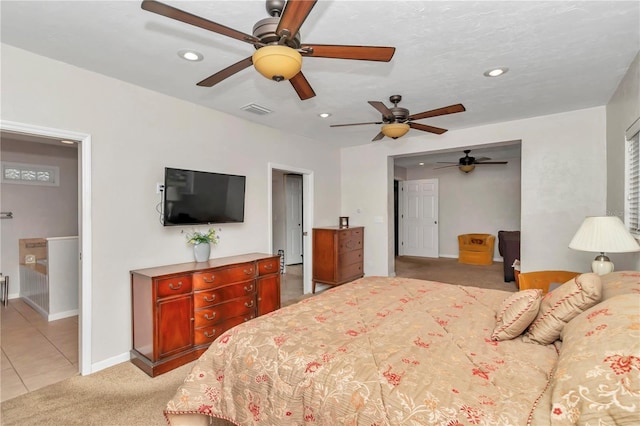 bedroom featuring light colored carpet and ceiling fan