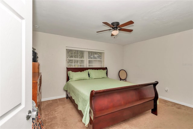 bedroom with ceiling fan and light carpet