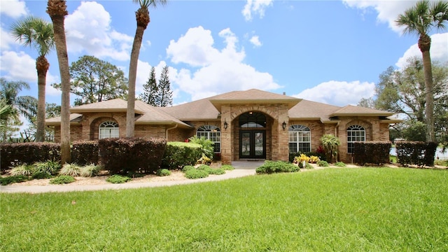 view of front of property with a front lawn and french doors