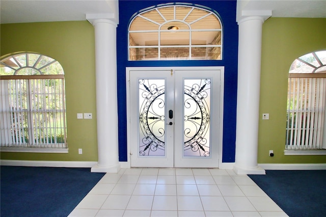 tiled foyer with ornate columns and french doors