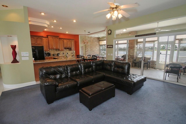 carpeted living room featuring ceiling fan