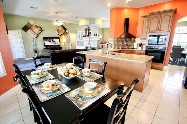 tiled dining space featuring sink and ceiling fan