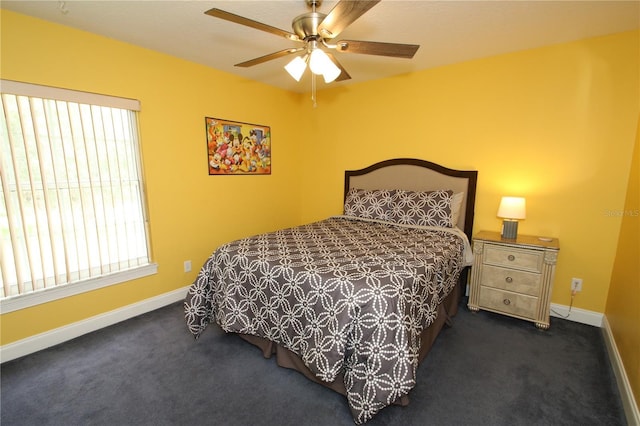 bedroom with ceiling fan and dark carpet