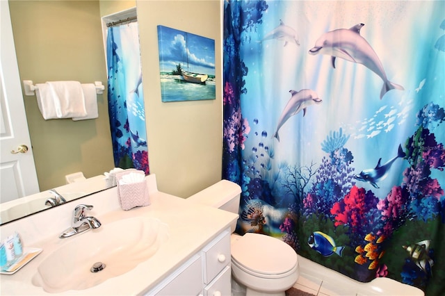 bathroom featuring walk in shower, vanity, and toilet