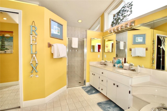 bathroom featuring tile patterned flooring, vanity, and tiled shower