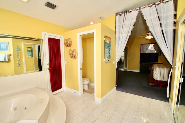 bathroom with a bathtub, tile patterned floors, and toilet