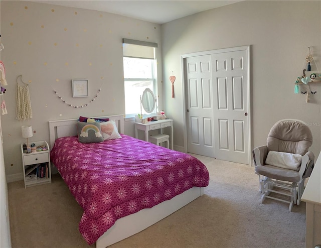 bedroom featuring light colored carpet and a closet