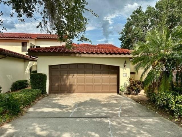 mediterranean / spanish-style home featuring a garage