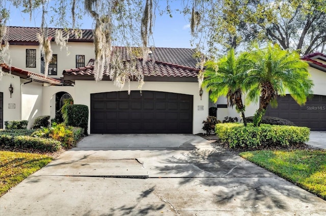 mediterranean / spanish house with a garage