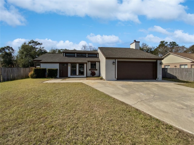 view of front facade with a garage and a front lawn