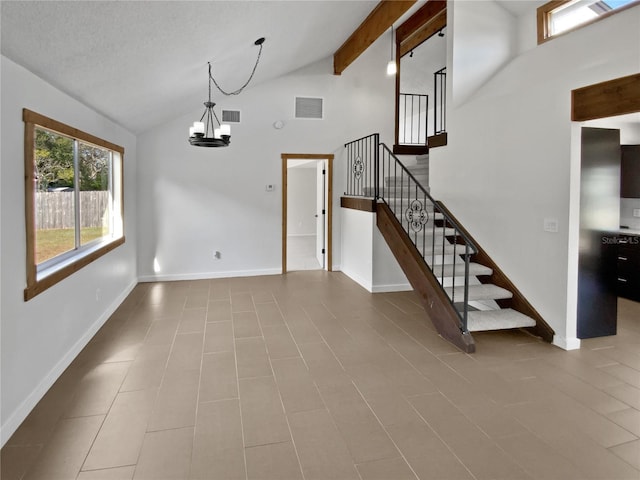 interior space with light tile patterned flooring, an inviting chandelier, high vaulted ceiling, a textured ceiling, and beam ceiling